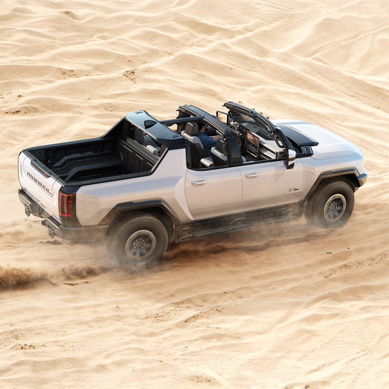 White GMC Hummer EV available at Folsom Buick GMC in FOLSOM, CA demonstrating off-road capability in desert terrain