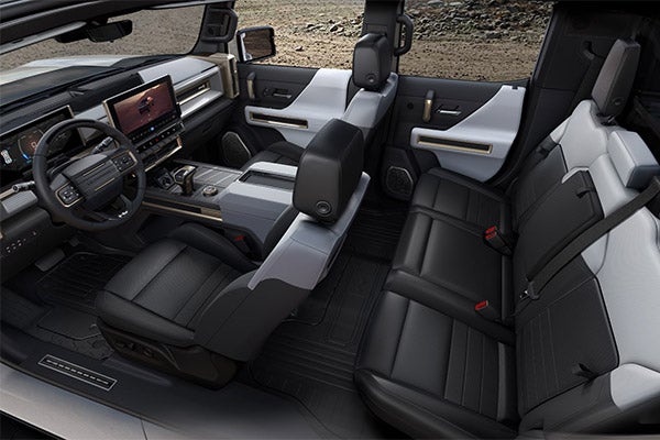 Folsom Buick GMC FOLSOM - Interior view of GMC Hummer EV showing spacious black leather seating across all rows with white trim accents