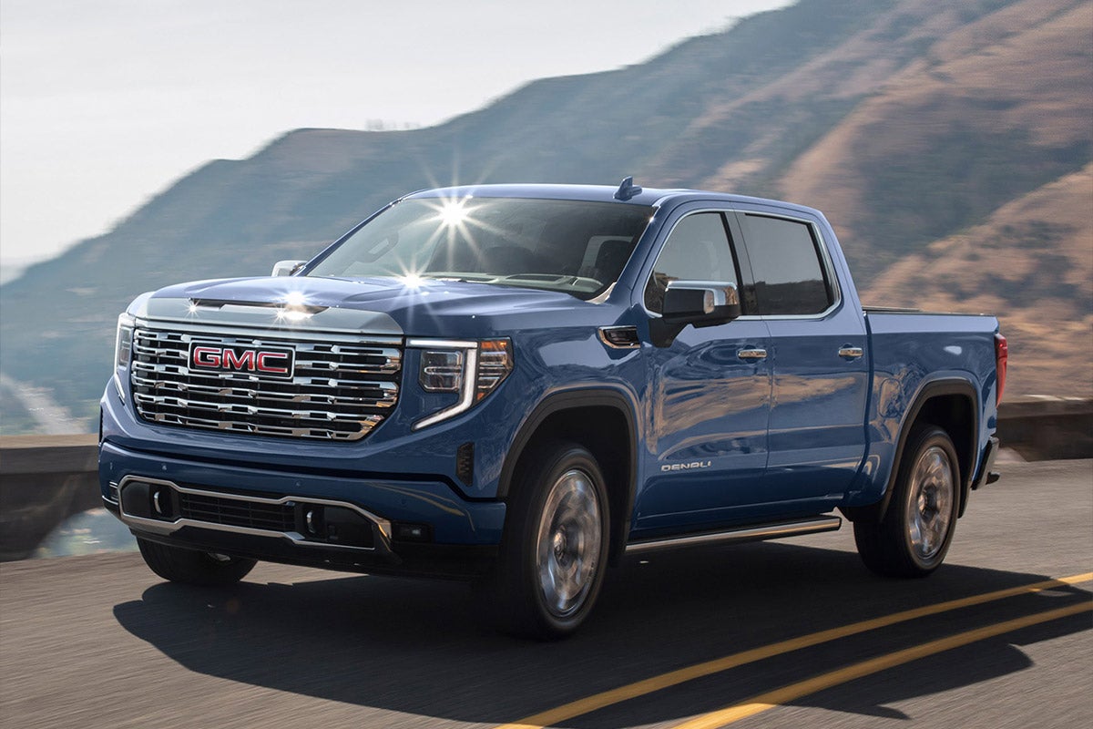 2025 GMC Sierra 1500 in Pacific Blue from Folsom Buick GMC FOLSOM driving on mountain road with LED lighting details