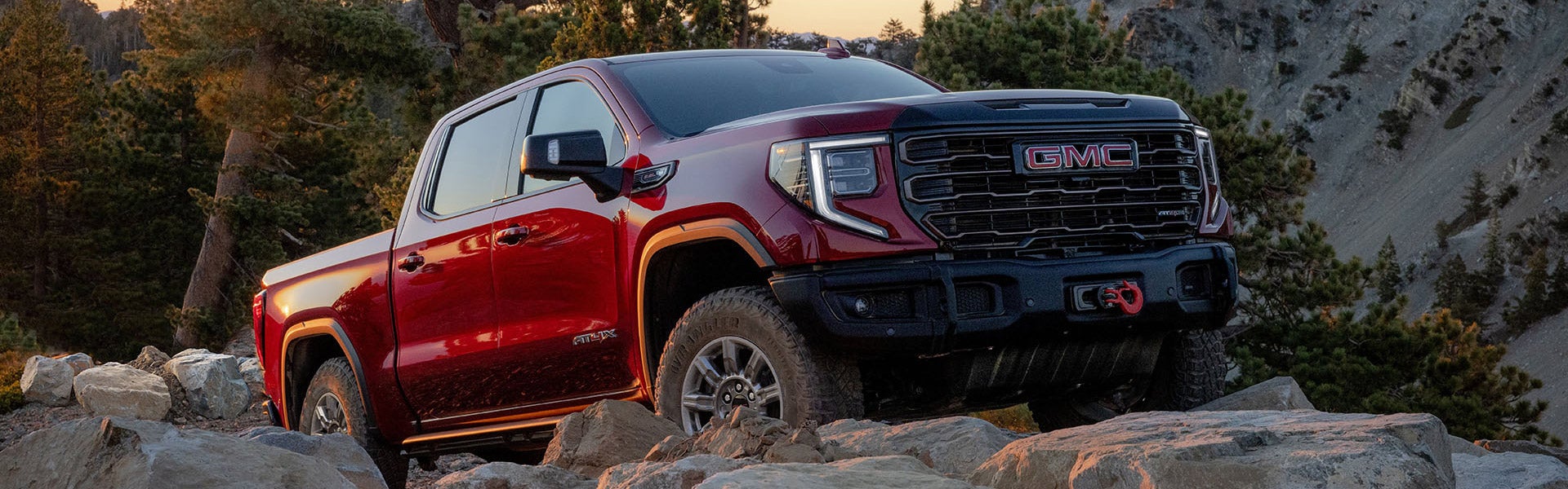 2025 GMC Sierra 1500 in Cardinal Red from Folsom Buick GMC in FOLSOM, CA showcasing off-road capability on rocky terrain